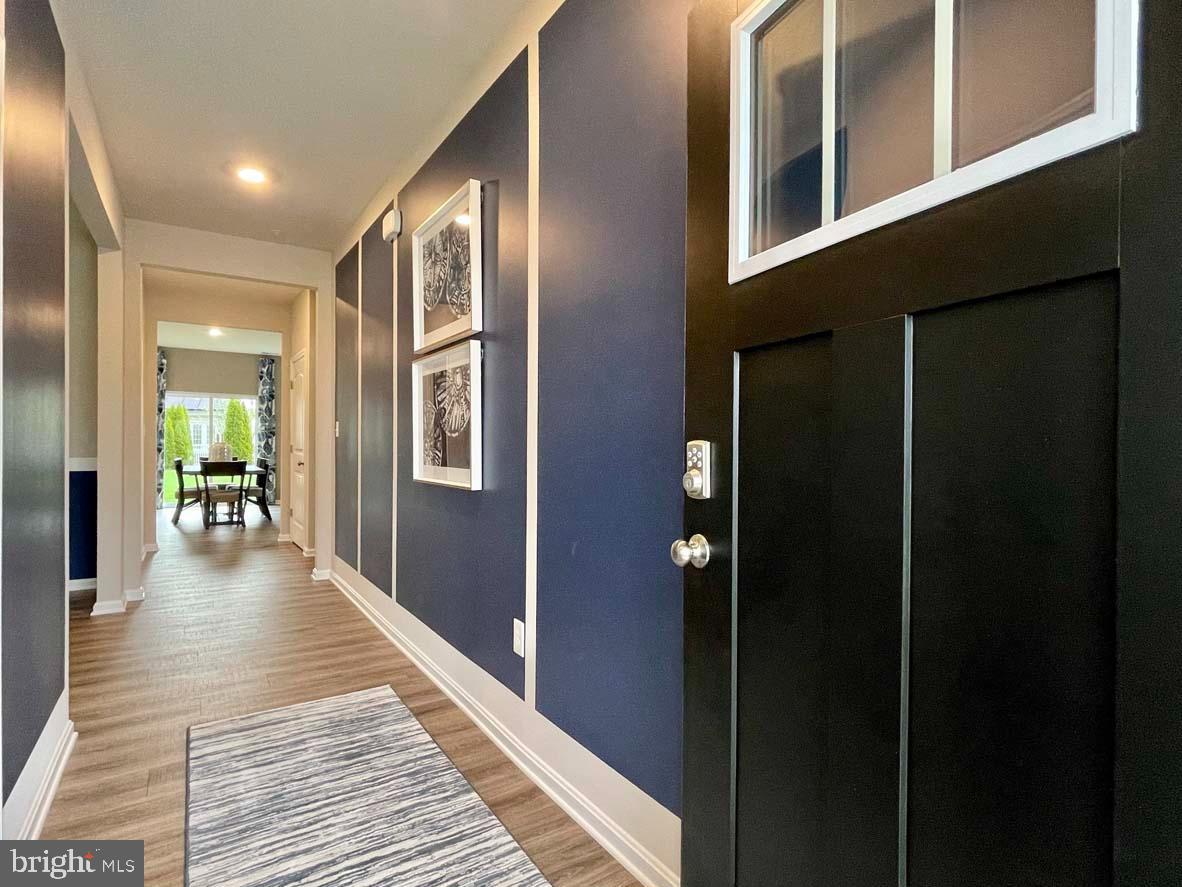 1145 Wintermead Loop Salisbury, MD 21801 - Photo 3 of 51 a hallway with wooden floor and a livingroom view