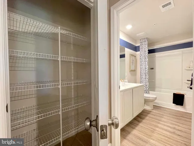 a bathroom with a double vanity sink mirror and toilet