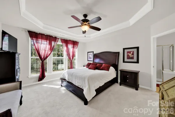 a bedroom with a large bed and a window