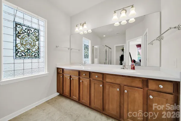 a spacious bathroom with a double vanity sink and a mirror