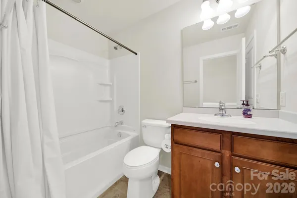 a bathroom with a sink toilet vanity and shower