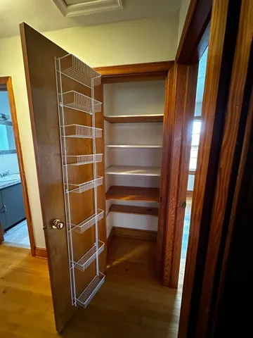 a view of walk in closet with empty racks