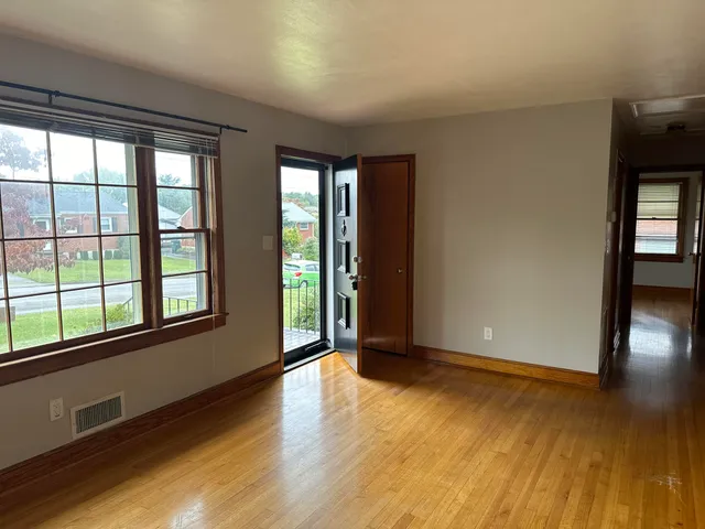 wooden floor in an empty room with a window