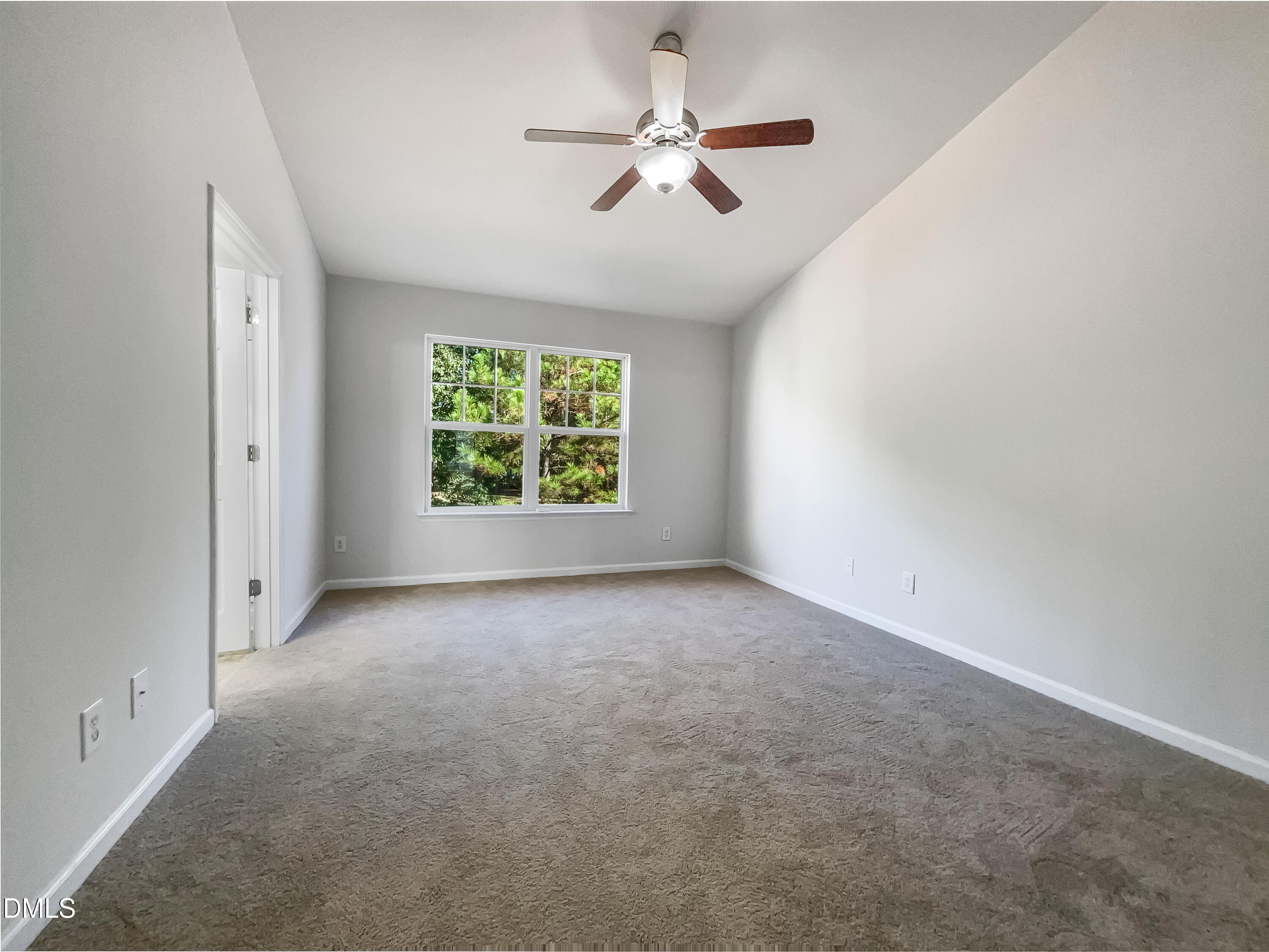 5107 Sandy Banks Road Raleigh, NC 27616 - Photo 5 of 21 an empty room with windows and ceiling fan