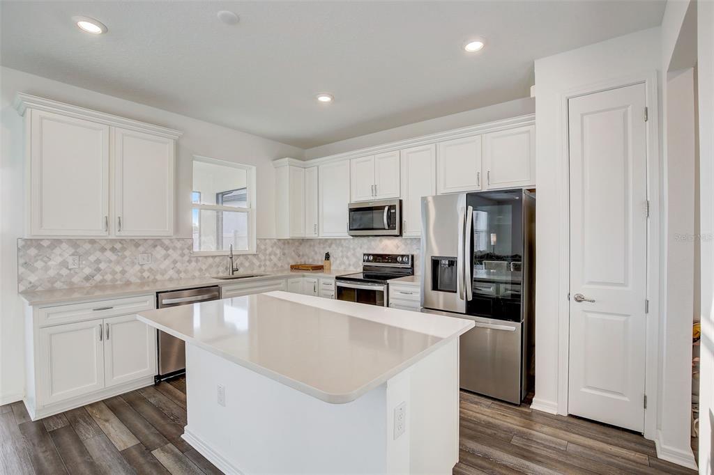 12918 Brookside Moss Drive Riverview, FL 33579 - Photo 14 of 43 a kitchen with cabinets a sink and stainless steel appliances