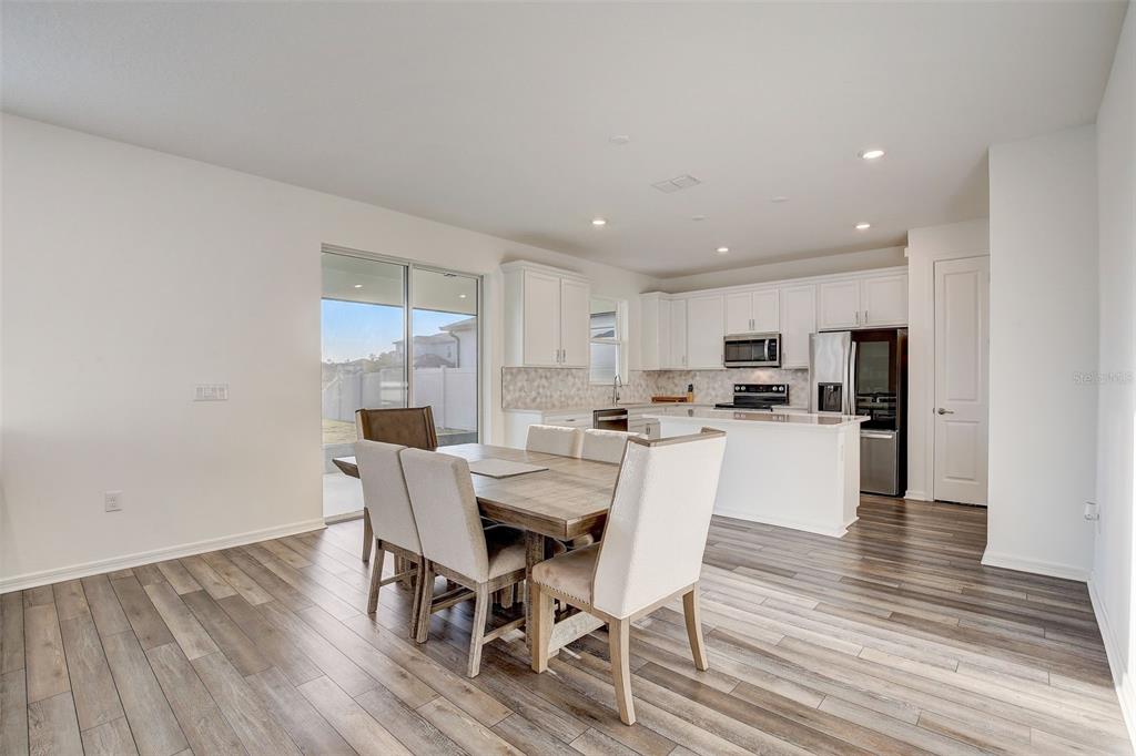 12918 Brookside Moss Drive Riverview, FL 33579 - Photo 10 of 43 a dining room with furniture and wooden floor
