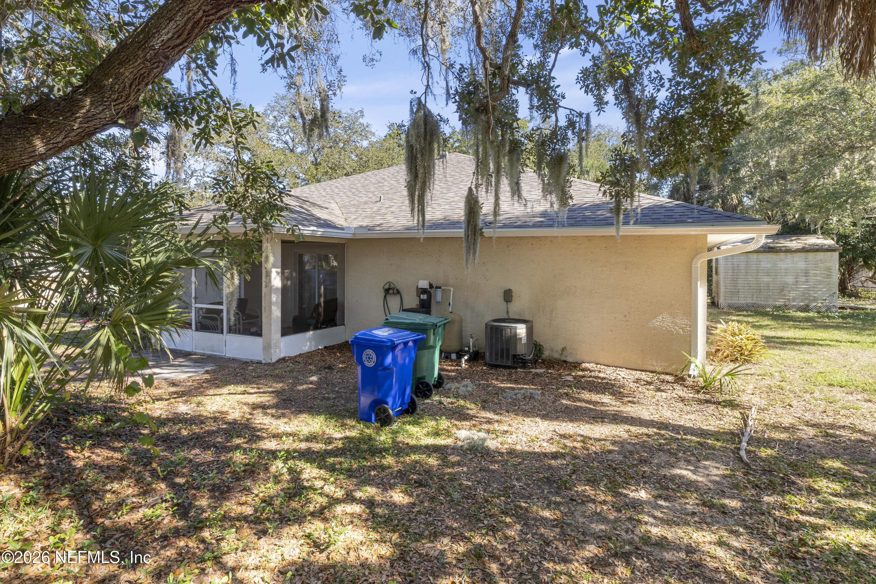 1022 Foster Road Sebastian, FL 32958 - Photo 27 of 30 a view of a backyard with table and chairs under an umbrella