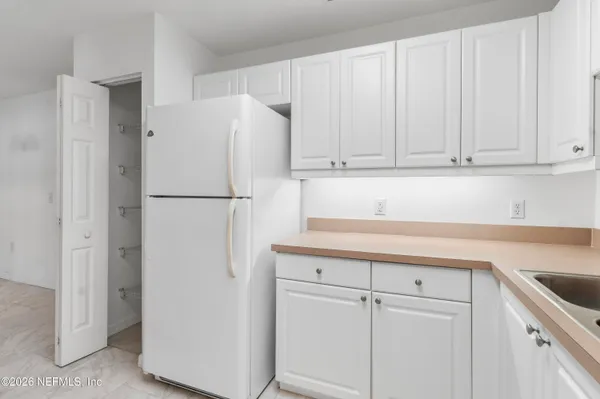 a white refrigerator freezer sitting in a kitchen