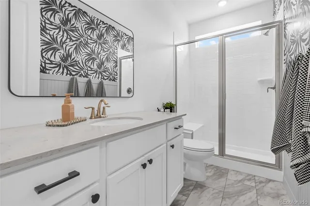 a view of a hallway with workspace and a couch