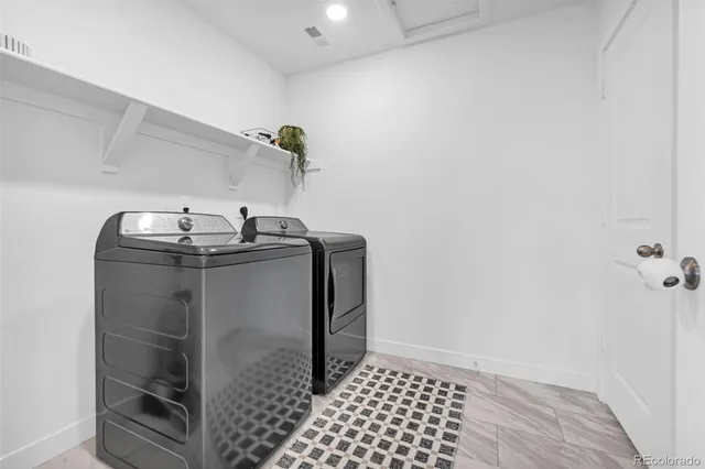 a bathroom with a granite countertop sink mirror vanity and toilet