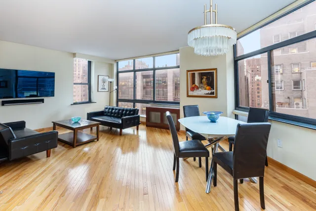 a living room with fireplace furniture and a chandelier