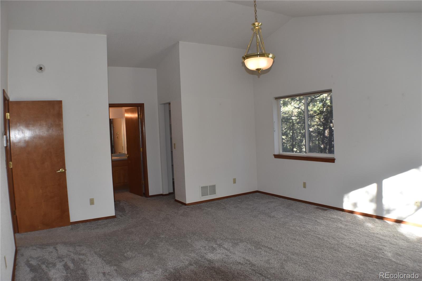 14540 Rosholt Loop Colorado Springs, CO 80921 - Photo 47 of 50 a view of an empty room with window and wooden floor