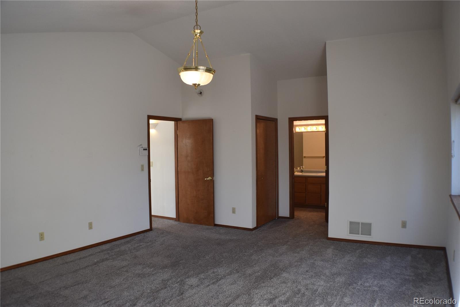 14540 Rosholt Loop Colorado Springs, CO 80921 - Photo 48 of 50 an empty room with closet and a chandelier fan