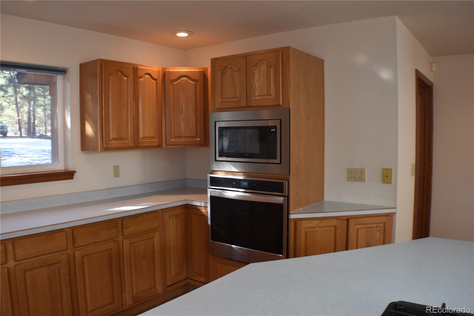 14540 Rosholt Loop Colorado Springs, CO 80921 - Photo 7 of 50 a kitchen with stainless steel appliances granite countertop a refrigerator and a stove top oven