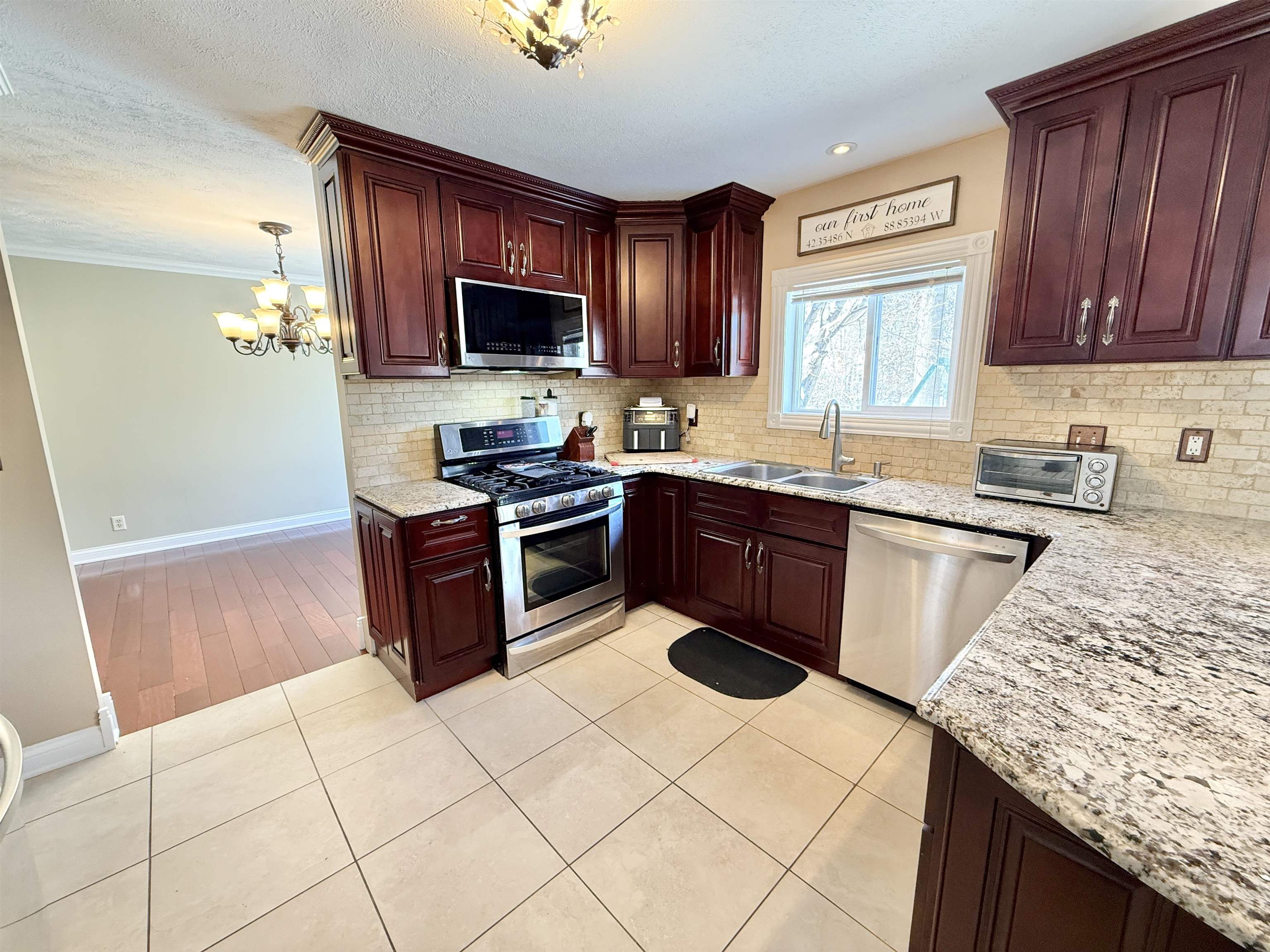 120 Lamplighter Loop Southeast Poplar Grove, IL 61065 - Photo 11 of 30 a kitchen with stainless steel appliances granite countertop a stove a sink dishwasher and a refrigerator