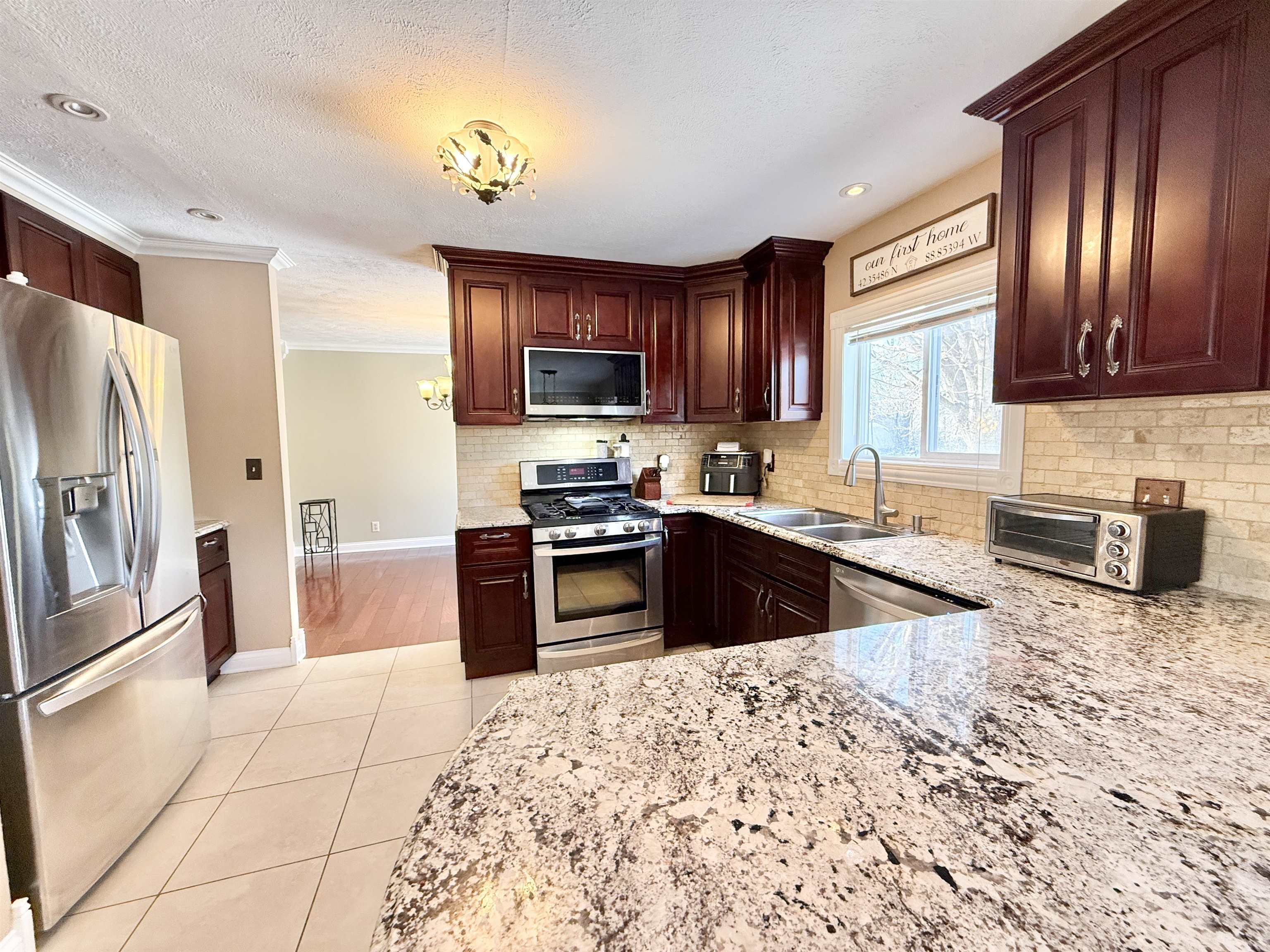 120 Lamplighter Loop Southeast Poplar Grove, IL 61065 - Photo 12 of 30 a kitchen with stainless steel appliances granite countertop a refrigerator sink and stove