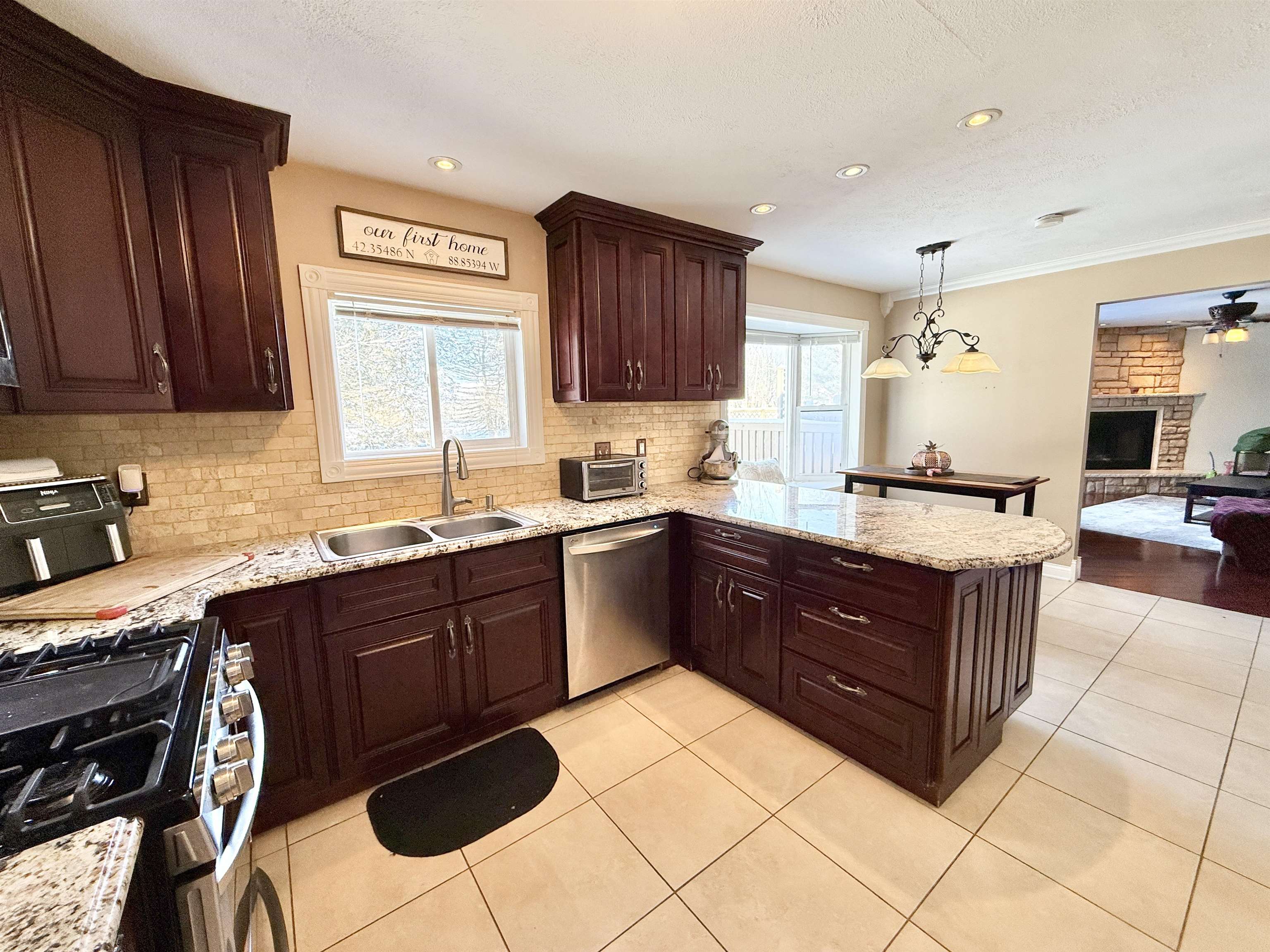 120 Lamplighter Loop Southeast Poplar Grove, IL 61065 - Photo 14 of 30 a kitchen with stainless steel appliances granite countertop wooden cabinets a sink and dishwasher