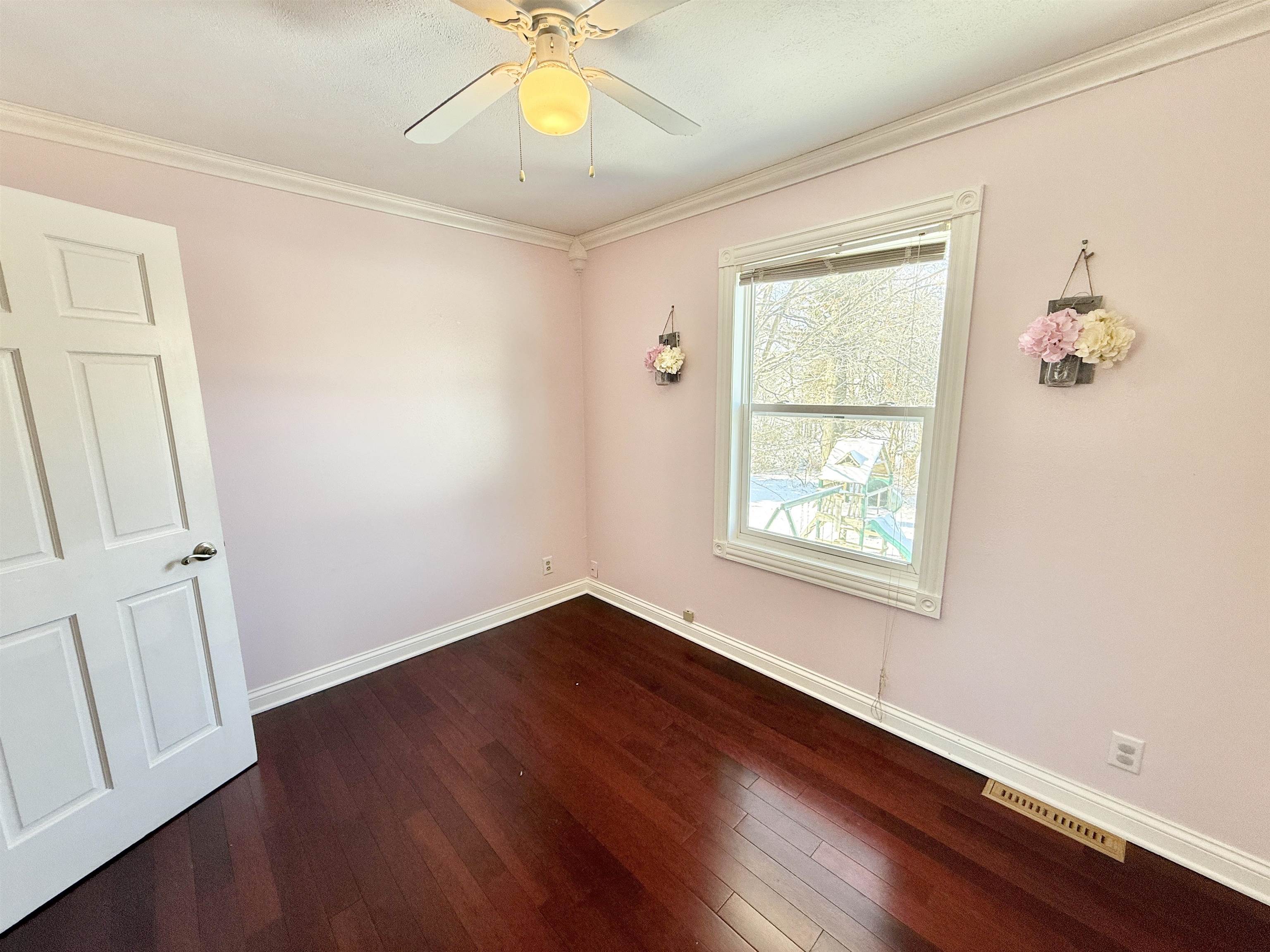 120 Lamplighter Loop Southeast Poplar Grove, IL 61065 - Photo 27 of 30 a view of an empty room with wooden floor and a window