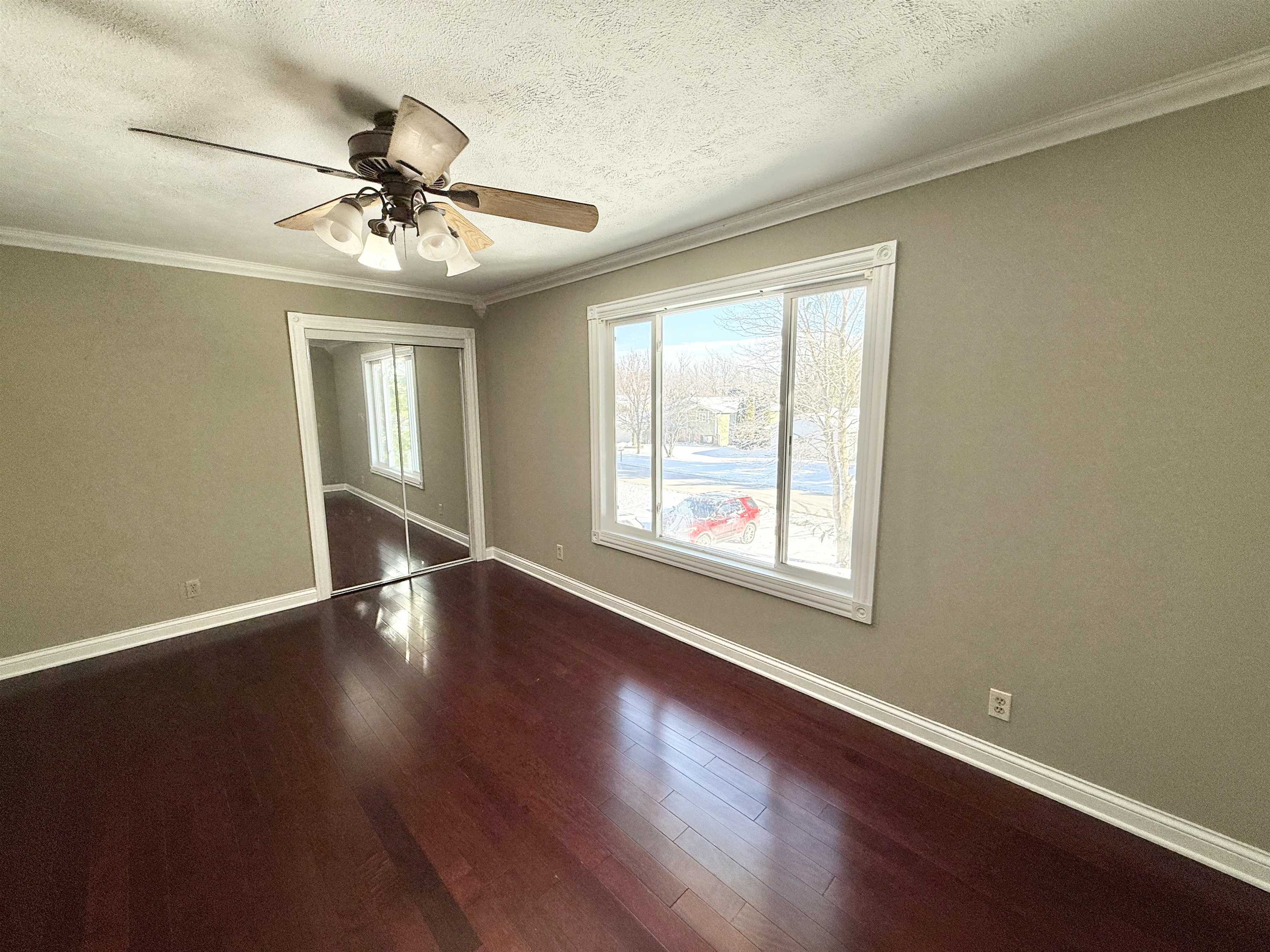 120 Lamplighter Loop Southeast Poplar Grove, IL 61065 - Photo 30 of 30 a view of an empty room with wooden floor and a window