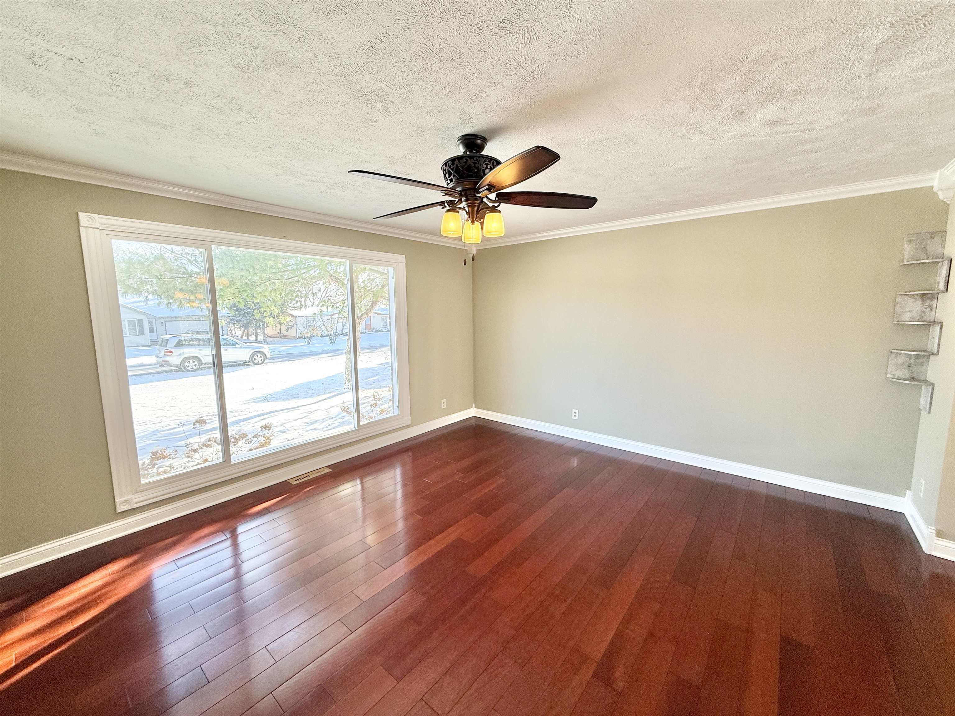 120 Lamplighter Loop Southeast Poplar Grove, IL 61065 - Photo 5 of 30 a view of an empty room with wooden floor and a window