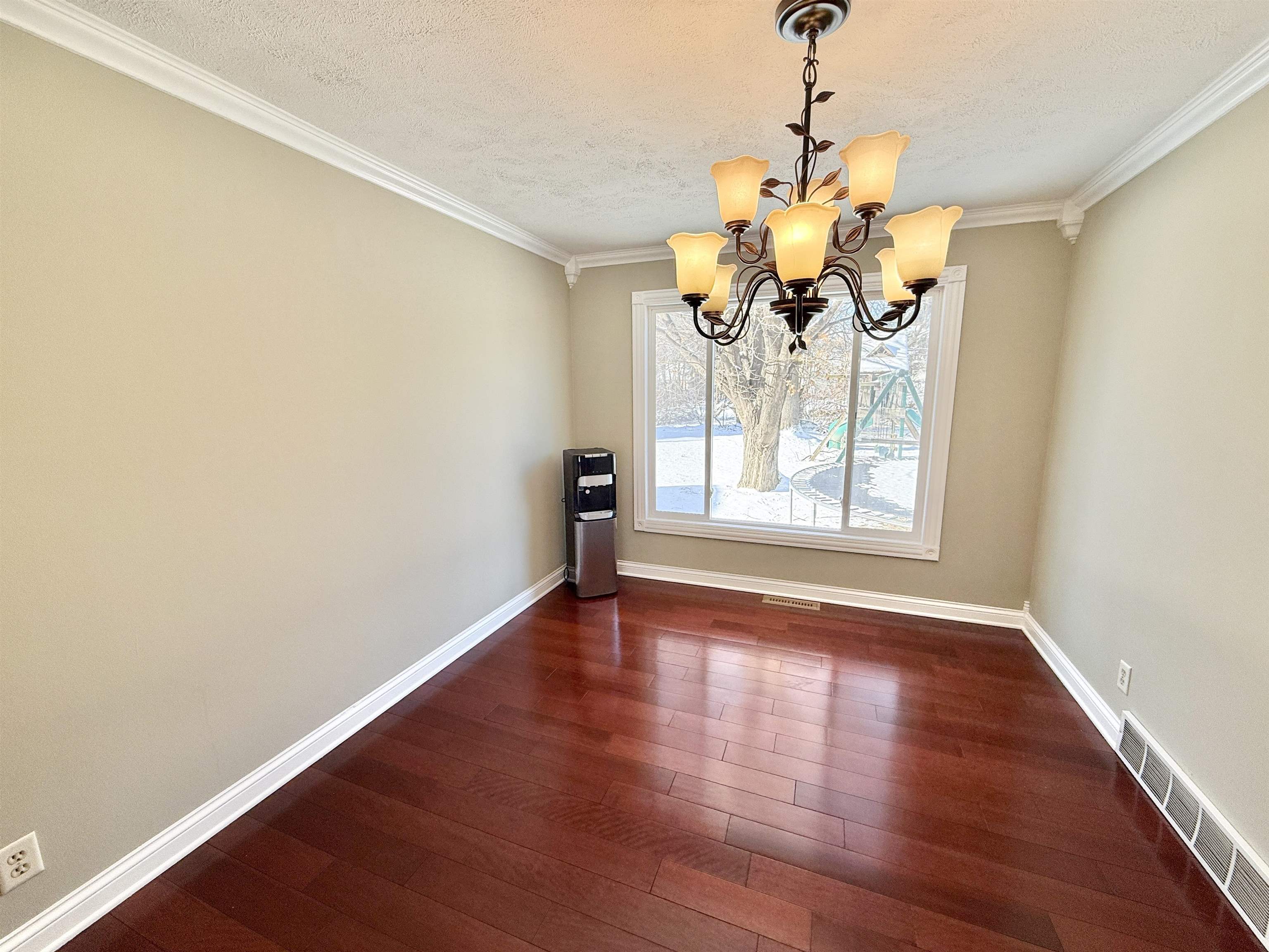 120 Lamplighter Loop Southeast Poplar Grove, IL 61065 - Photo 8 of 30 a view of a room with wooden floor chandelier and a window