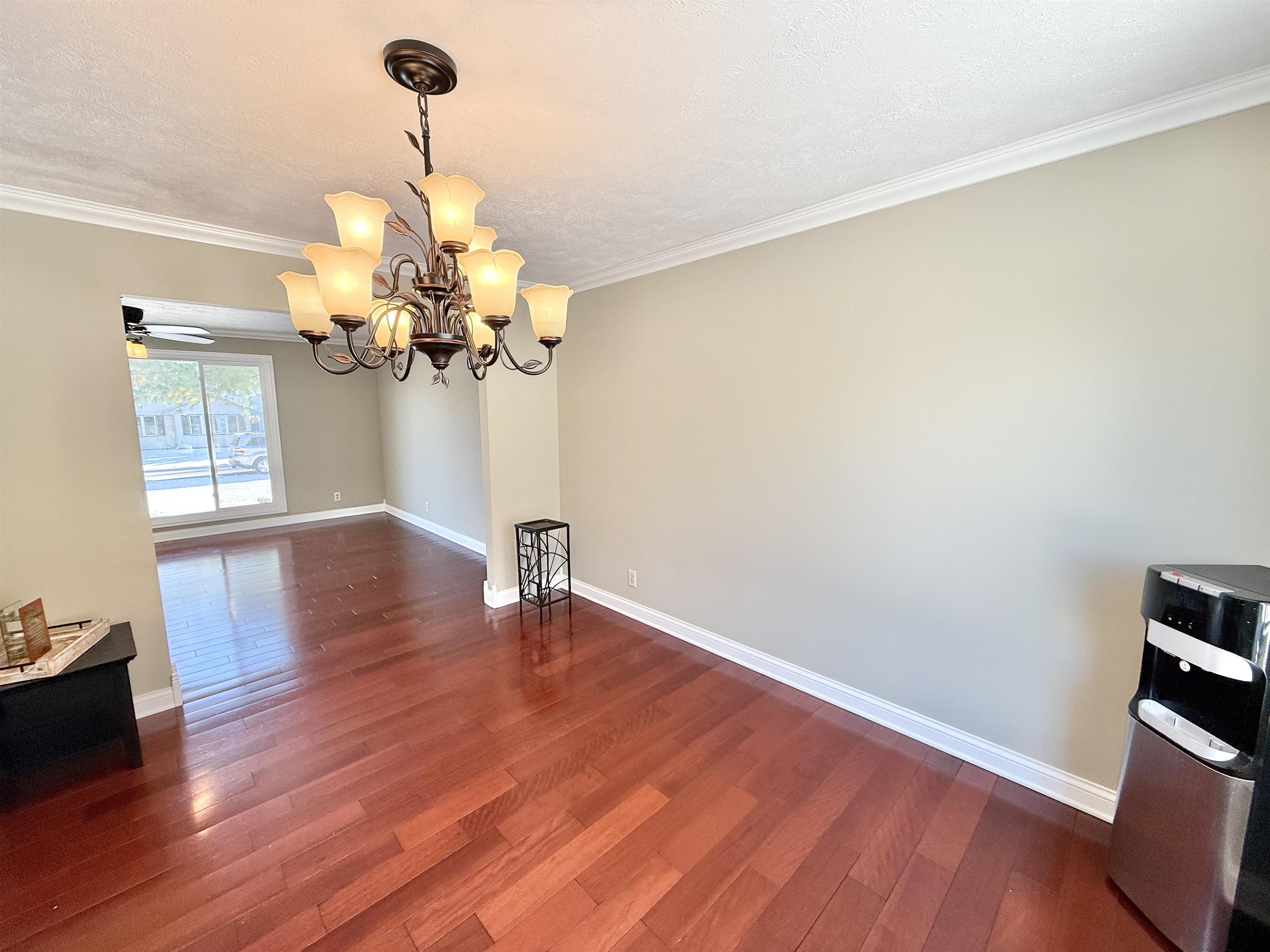 120 Lamplighter Loop Southeast Poplar Grove, IL 61065 - Photo 9 of 30 a view of a room with wooden floor and chandelier