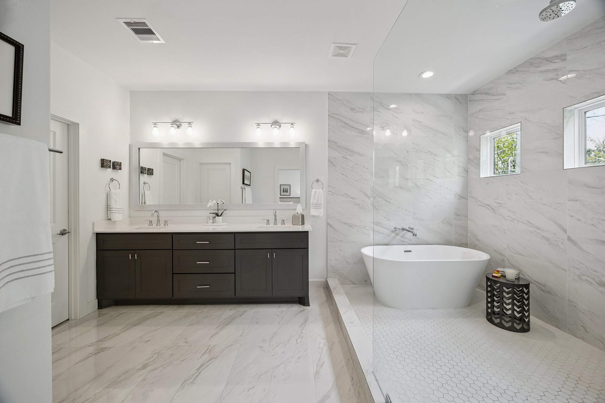 1747 Ojeman Point Lane Houston, TX 77055 - Photo 15 of 24 The well-appointed primary suite is spacious and features Carrara marble flooring and a wet room wall surround.