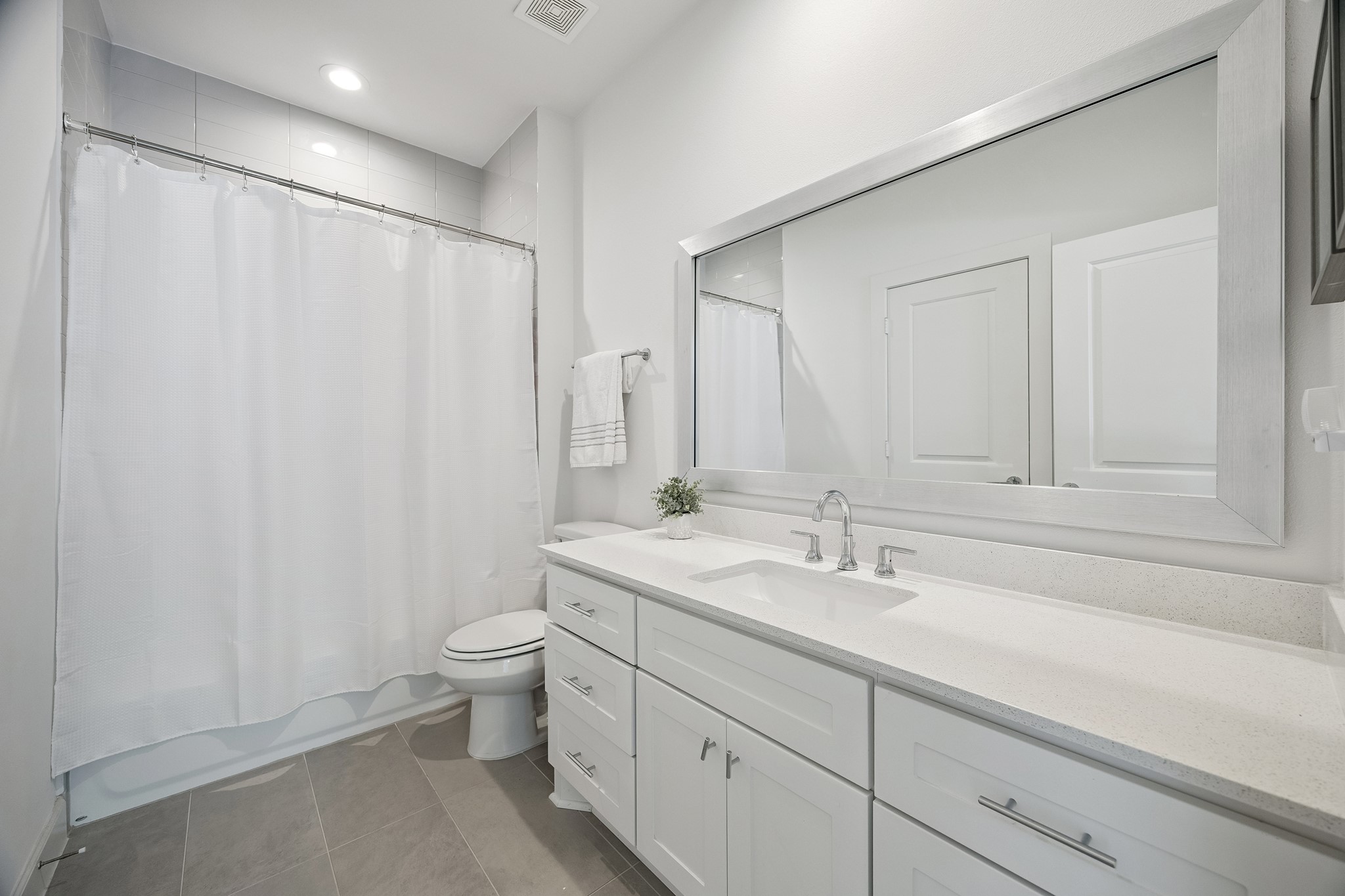 1747 Ojeman Point Lane Houston, TX 77055 - Photo 19 of 24 The upstairs shared bathroom features quartz countertops and additional storage below.