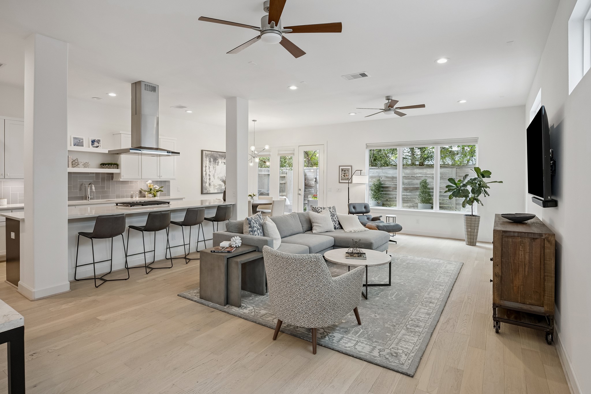 1747 Ojeman Point Lane Houston, TX 77055 - Photo 6 of 24 The living room features high ceilings, hardwood floors, and oversized windows that showcase beautiful views of the backyard.