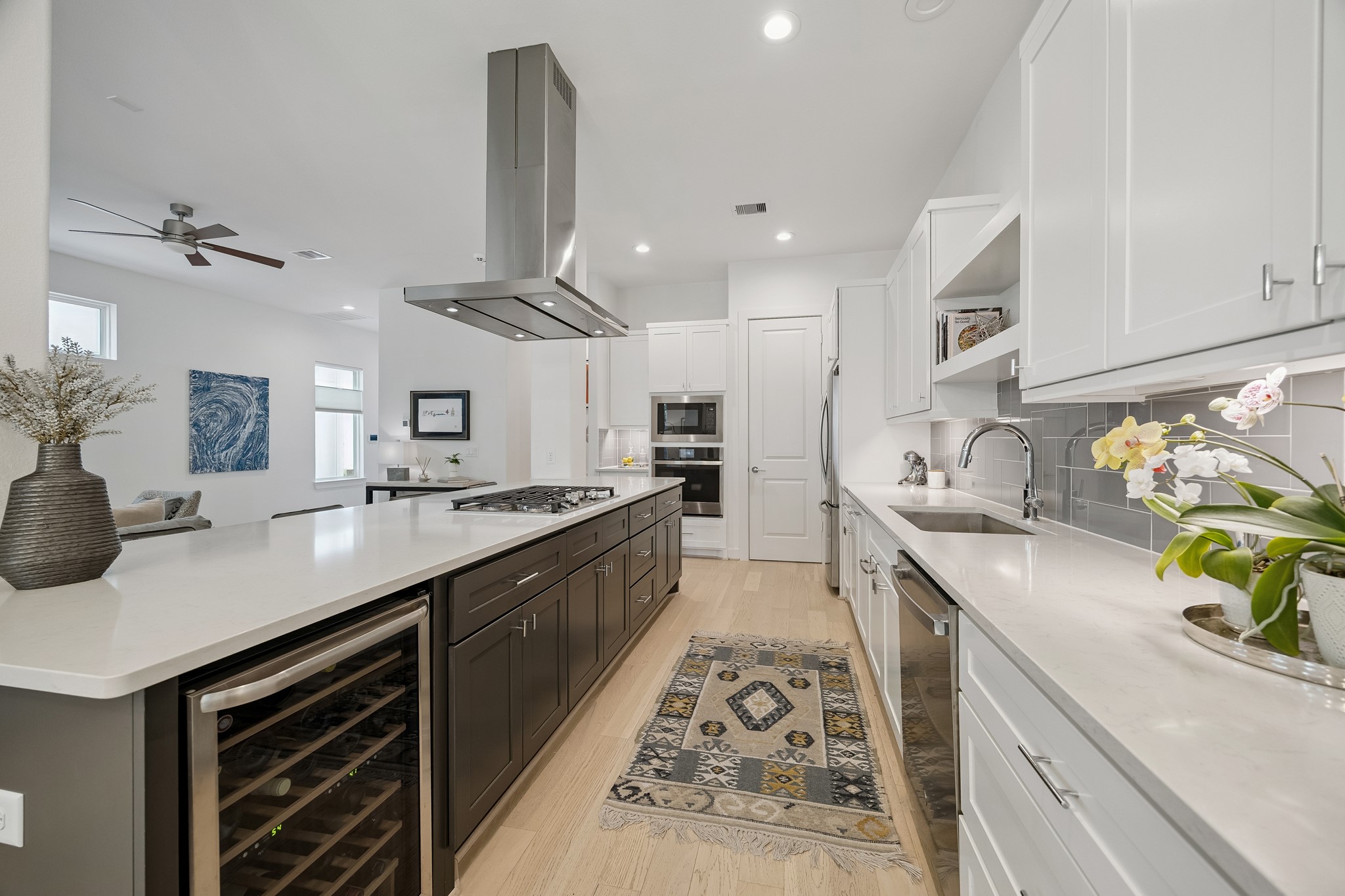 1747 Ojeman Point Lane Houston, TX 77055 - Photo 8 of 24 Generous in size, the quartz island kitchen with stainless steel appliances and a beverage fridge is ideal for entertaining.