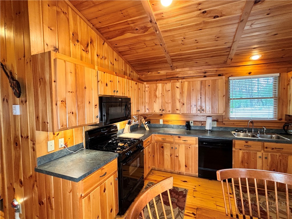 150 Turkey Ridge Crumpler, NC 28617 - Photo 26 of 40 a kitchen with stainless steel appliances granite countertop a stove a sink and a microwave