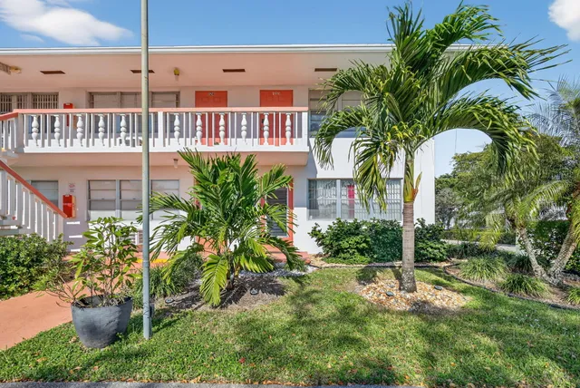 a view of a balcony with a potted plants and palm trees
