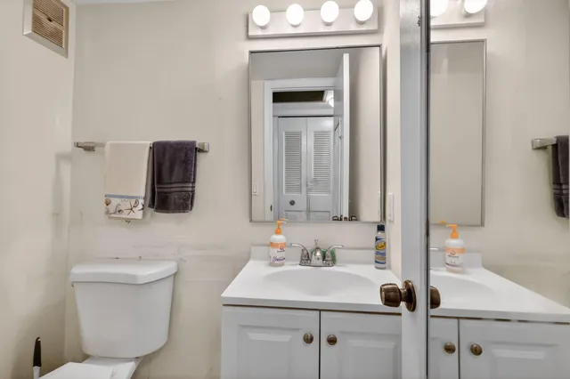 a bathroom with a sink toilet and mirror