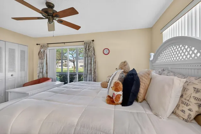 a bedroom with a bed and a large window