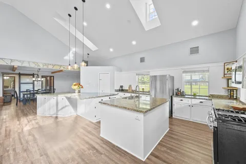 a view of living room filled with furniture and wooden floor