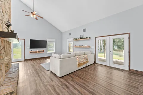 a living room with furniture and a wooden floor