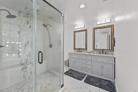 a white bath tub sitting next to a white sink