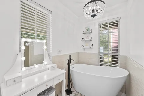 a bathroom with a granite countertop toilet a sink and a mirror