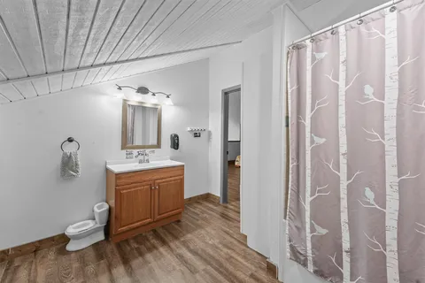 a view of a livingroom with wooden floor and windows