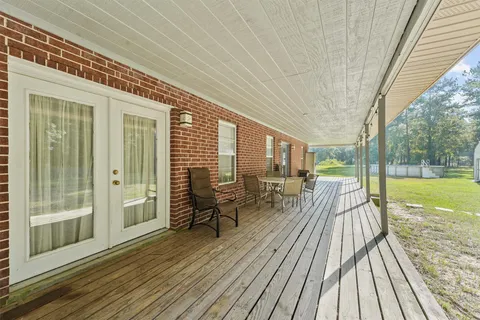 a view of a house with backyard and balcony