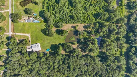a view of a yard and swimming pool