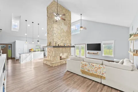 a kitchen with stainless steel appliances granite countertop a sink stove and wooden floor
