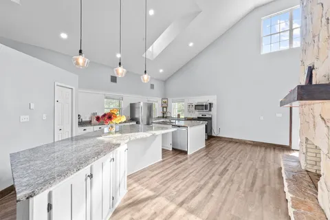 a kitchen with stainless steel appliances granite countertop a sink stove and cabinets