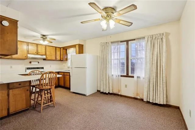 a view of a kitchen with furniture and a ceiling fan