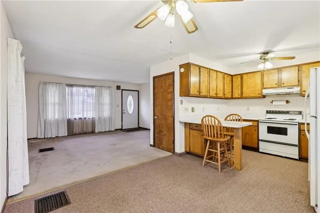 a view of kitchen with table and chairs