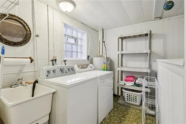 a utility room with sink dryer and washer