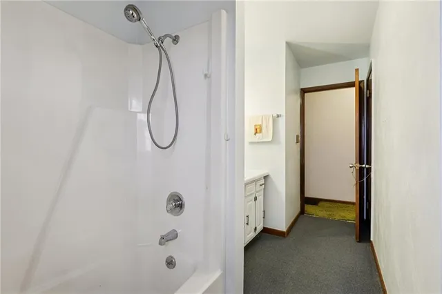 a bathroom with a glass shower door