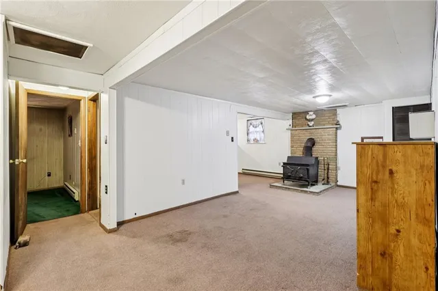 a view of a livingroom with furniture and a refrigerator