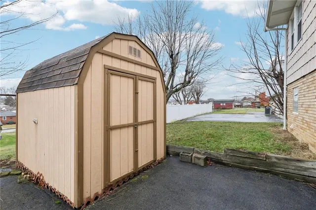 a backyard of a house with a garden and plants