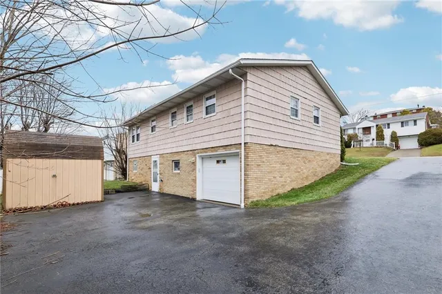 a view of a house with a yard and garage